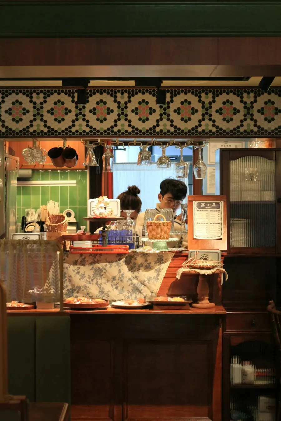 Two people working behind a café counter