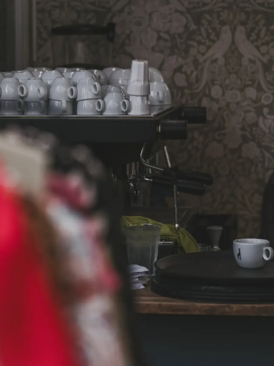 Espresso machine with stacked white cups